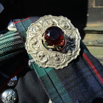 What does a bagpiper wear plaid brooch