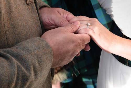 Exchange of rings at St Anthony's Chapel elopement ceremony in Edinburgh