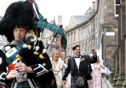 Bagpiper leading a Wedding Party